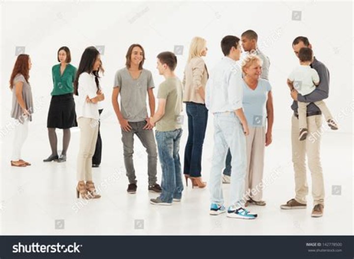 a group of people standing next to each other in front of a building