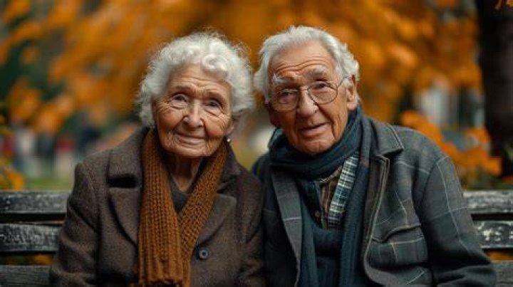 an older man and woman are walking down the red carpet