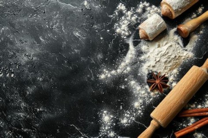 Baking background with free space for your text. Rolling pin and flour