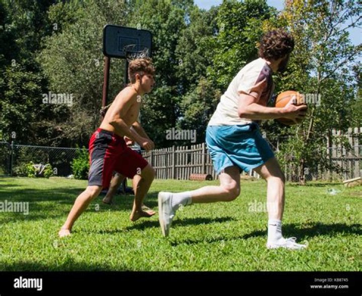 Brothers Playing Basketball Stock Photo Alamy