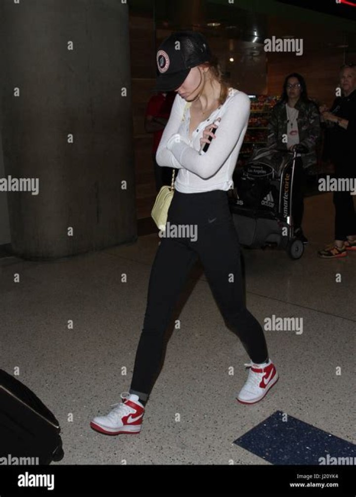 Camera shy Lily Rose Depp arrives at Los Angeles International Airport