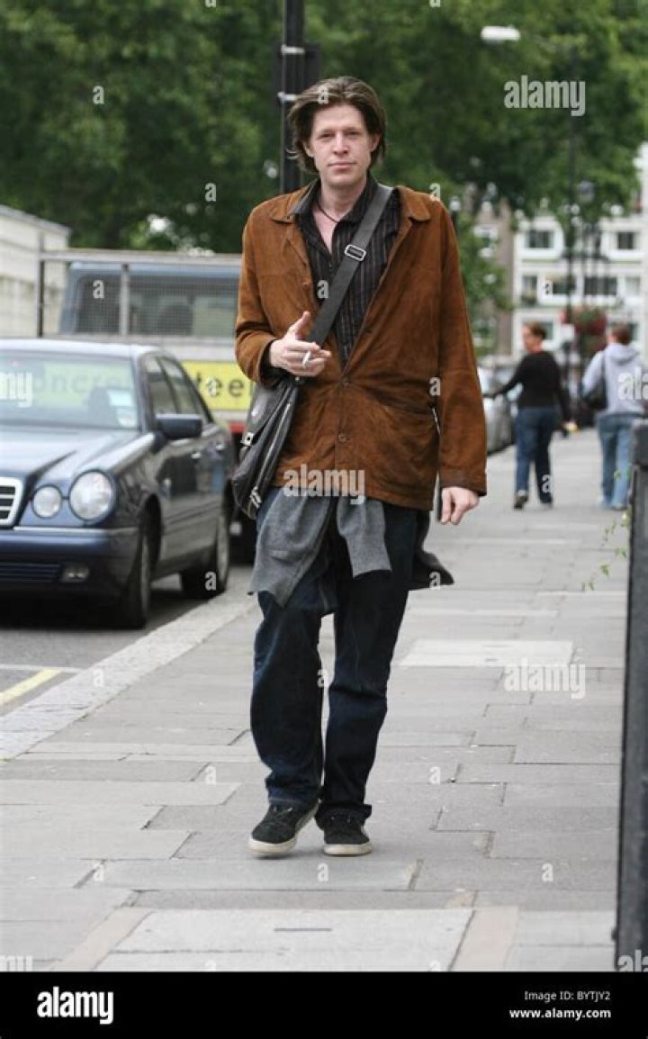 Chris Brosnan takes a cigarette from a photographer, then asks him for