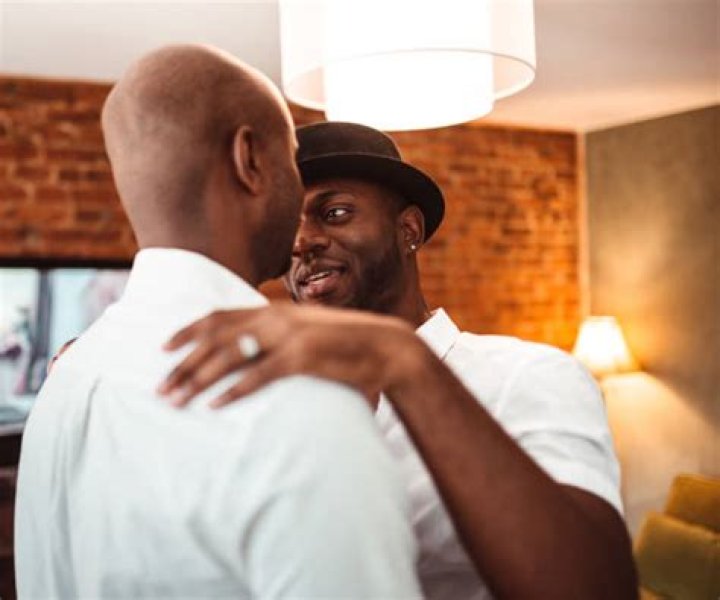 Gay Couple Dancing And Kissing At Party Stock Photo Download Image
