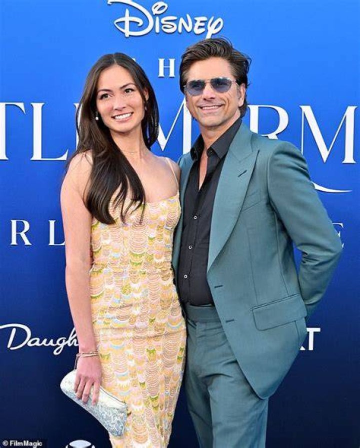 John Stamos, 59, poses with his wife Caitlin McHugh, 37, and son Billy