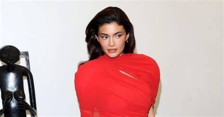 Kylie Jenner flaunts curvaceous figure in clinging aqua dress for