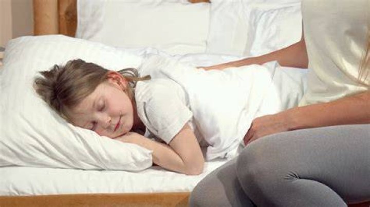 Mother Tenderly Tucking In Sleeping Child Stock Footage SBV335714656