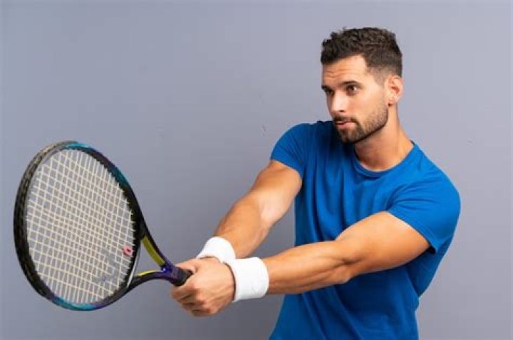 Premium Photo Handsome young tennis player man isolated on ocher