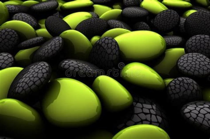 several green and black rocks sitting next to each other on a white