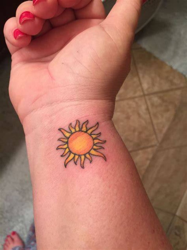Sun tattoo on wrist with color. You are my sunshine Sun tattoo