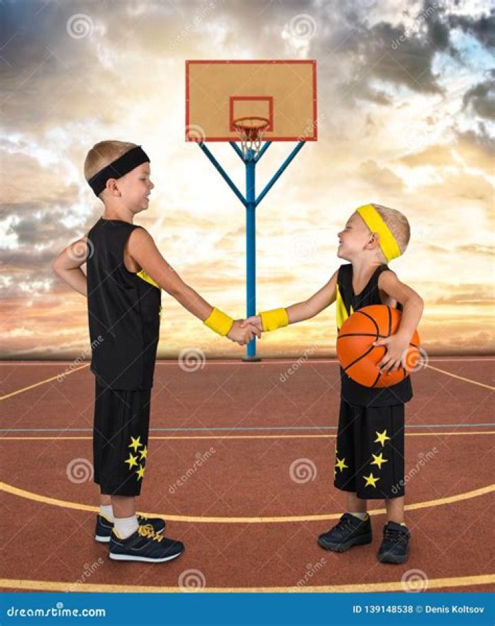Two Brothers Playing Basketball in the Street. Stock Photo Image of